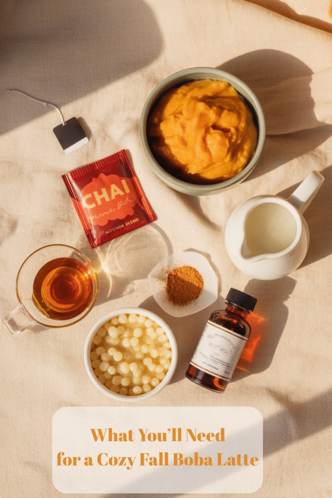 “Ingredients for Pumpkin Chai Boba Latte: chai tea, pumpkin purée, maple syrup, pumpkin pie spice, vanilla extract, uncooked tapioca pearls, and milk on a linen background.”