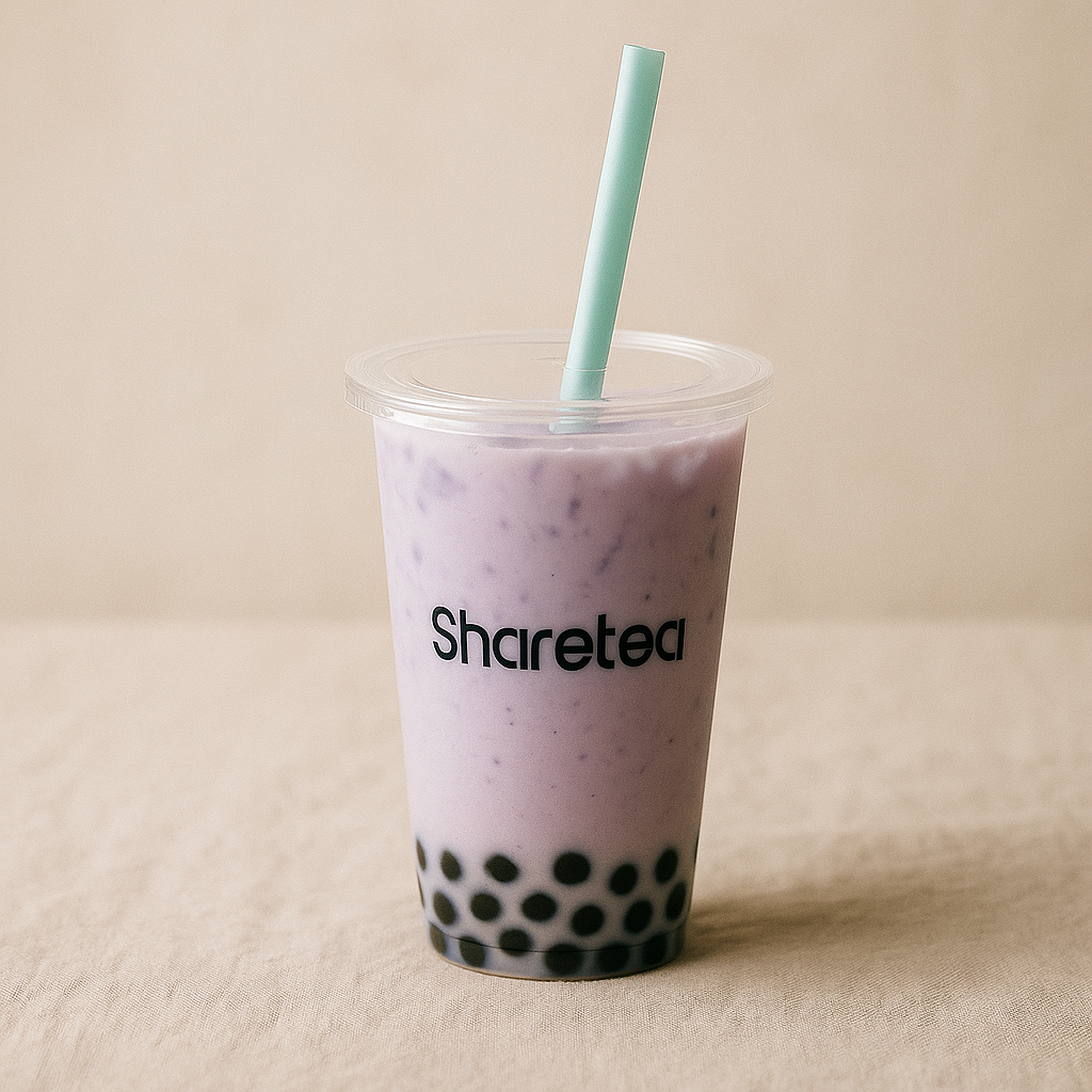 “Sharetea taro bubble tea in a clear plastic cup with black tapioca pearls, pastel purple drink, flat lid and mint straw, photographed on a soft beige tablecloth with a warm light background.”