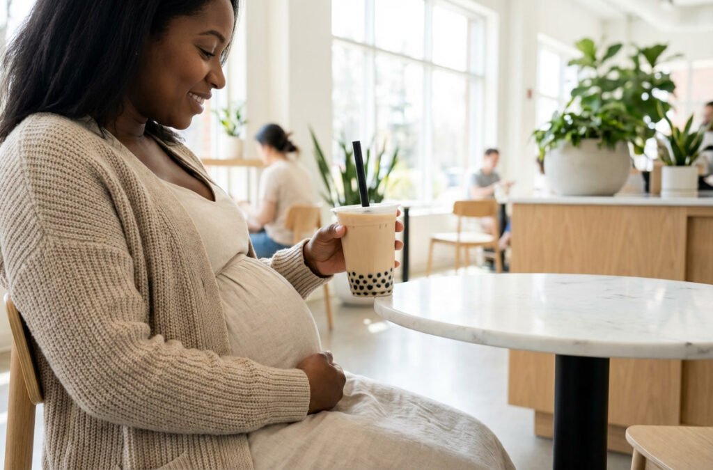 Pregnant woman drinking bubble tea in a cafe