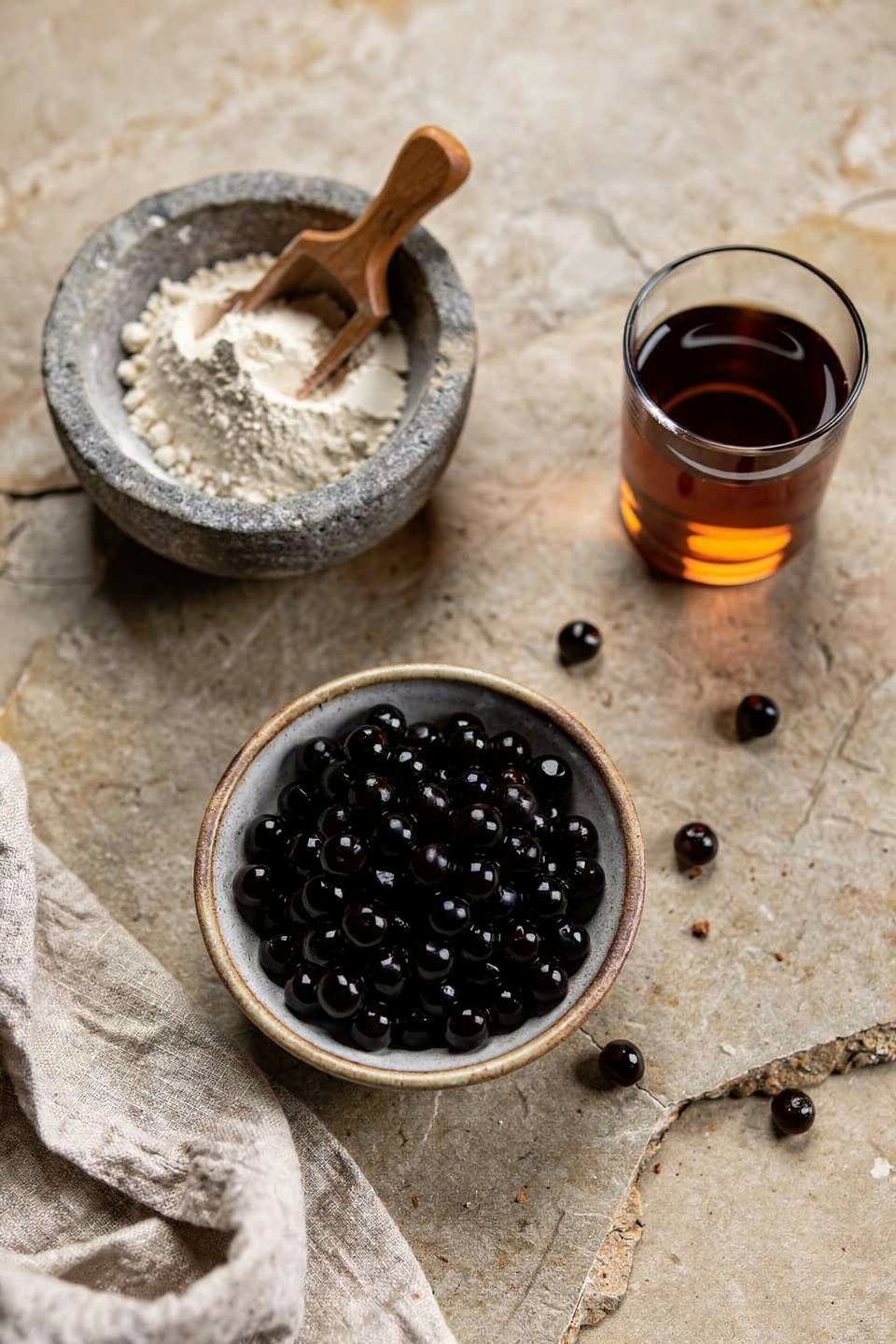 ingredients for high protein bubble tea with protein powder, black tea, and tapioca pearls
