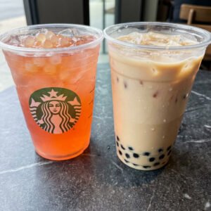 Starbucks refresher with pearls beside traditional milk tea with tapioca boba