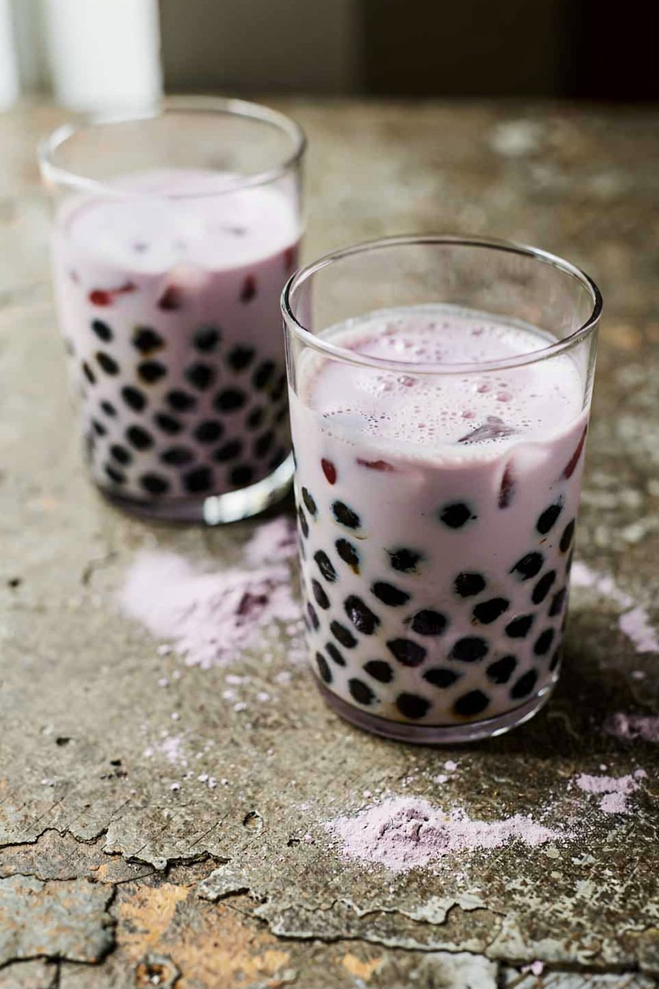 two glasses of classic taro milk tea with black tapioca pearls